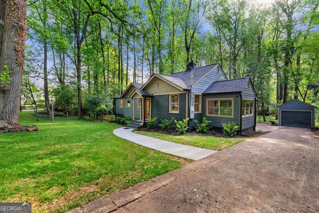 1186 Thomas Rd, Decatur, GA 30030 - view of front of house featuring an outbuilding, a garage, and a front lawn