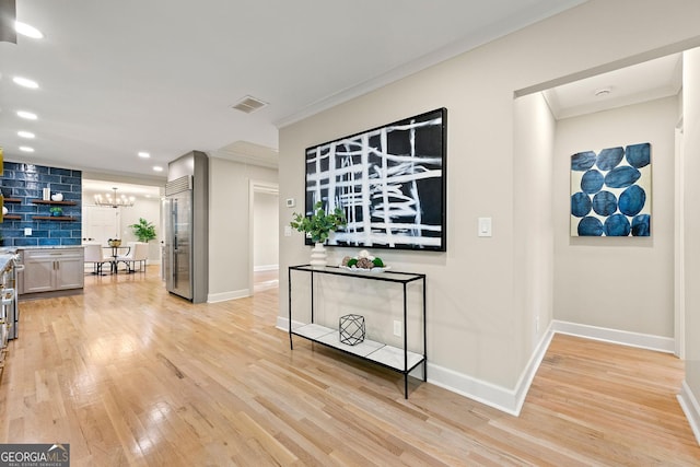 1186 Thomas Rd, Decatur, GA 30030 - hall with ornamental molding, a chandelier, light wood-style floors, baseboards, and recessed lighting