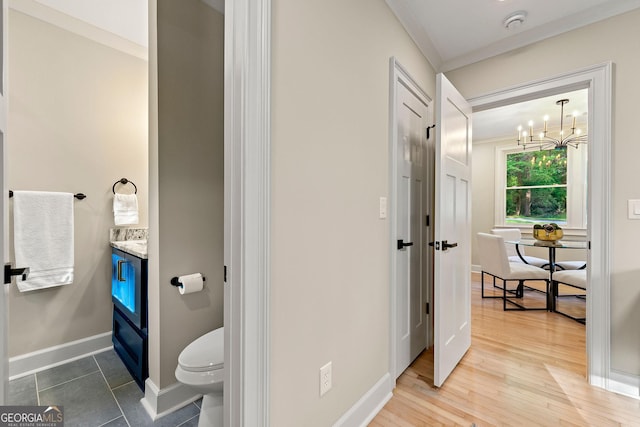 1186 Thomas Rd, Decatur, GA 30030 - bathroom with vanity, toilet, a chandelier, baseboards, and crown molding