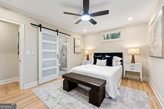 1186 Thomas Rd, Decatur, GA 30030 - bedroom with a barn door, wood finished floors, crown molding, baseboards, and recessed lighting