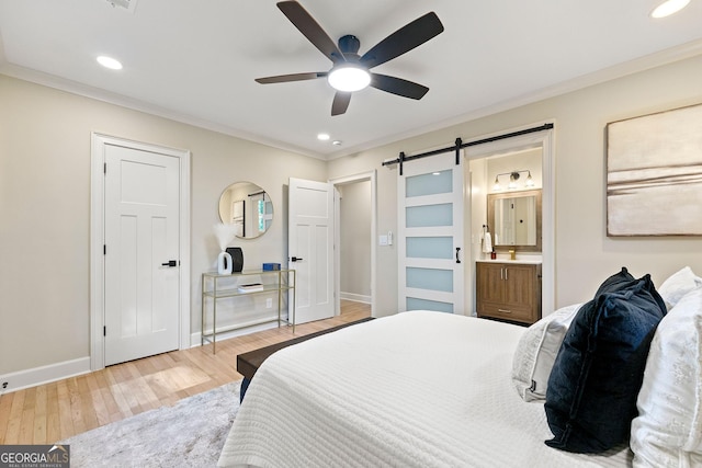1186 Thomas Rd, Decatur, GA 30030 - bedroom featuring a barn door, wood finished floors, baseboards, ornamental molding, and recessed lighting