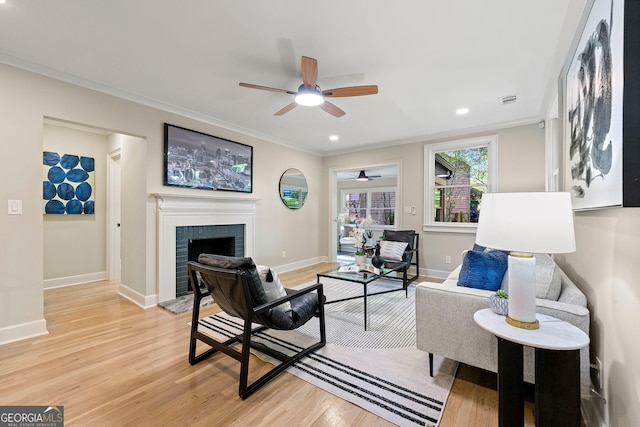 1186 Thomas Rd, Decatur, GA 30030 - living area with ceiling fan, crown molding, light wood finished floors, baseboards, and a brick fireplace