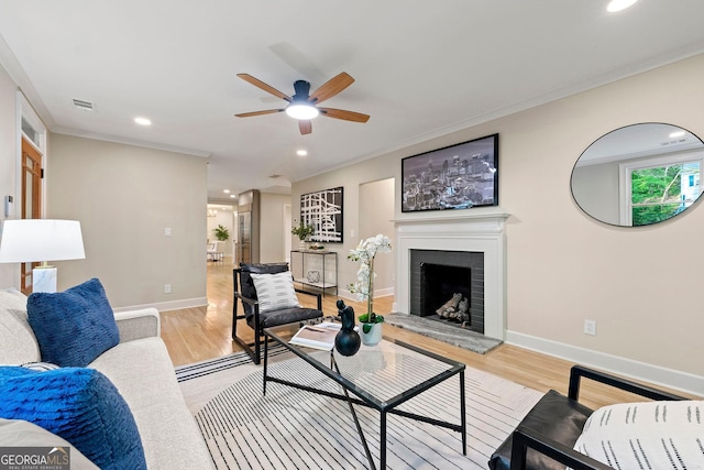 1186 Thomas Rd, Decatur, GA 30030 - living area featuring a ceiling fan, light wood-style flooring, baseboards, recessed lighting, and a fireplace with raised hearth