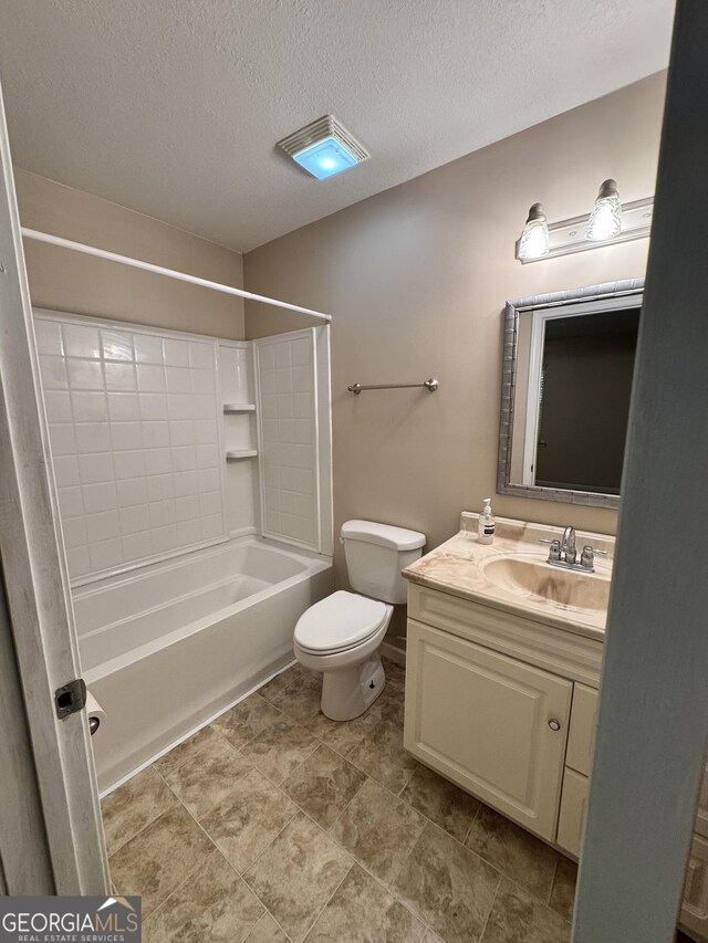 bathroom featuring a textured ceiling, toilet, vanity, and shower / tub combination