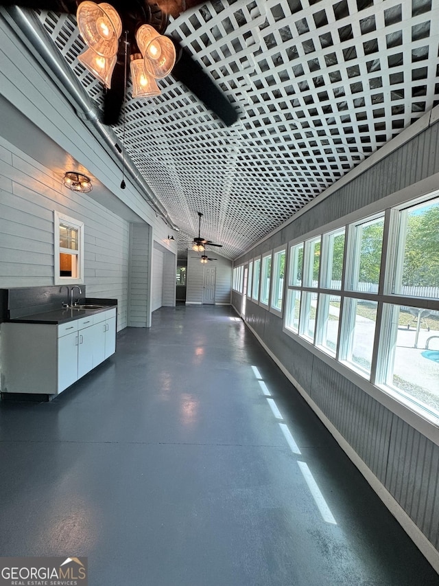 corridor featuring a sink and plenty of natural light