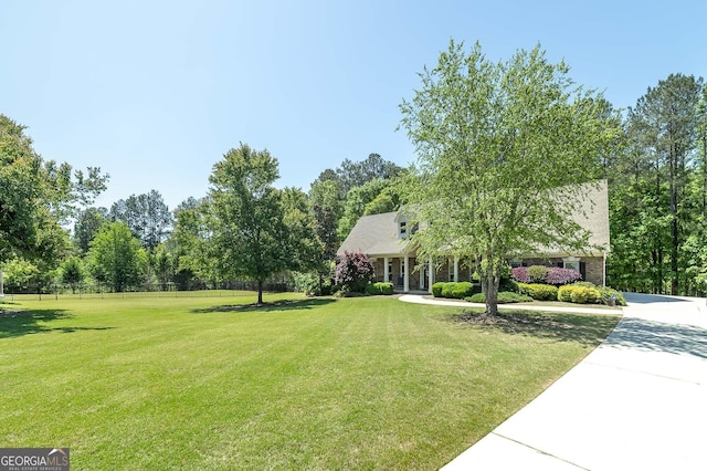 330 Noah Pl, Mcdonough, GA 30252 - cape cod house featuring a front yard, driveway, and fence