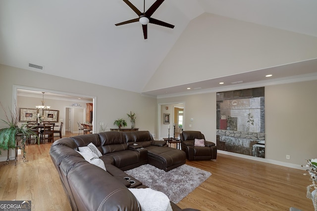 330 Noah Pl, Mcdonough, GA 30252 - living room with light wood-type flooring, visible vents, high vaulted ceiling, and ceiling fan with notable chandelier