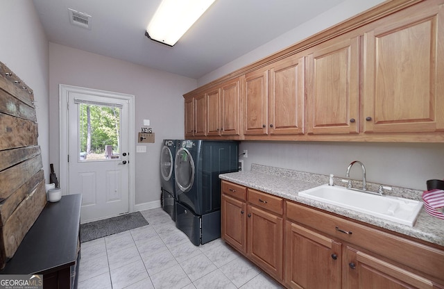 330 Noah Pl, Mcdonough, GA 30252 - clothes washing area with light tile patterned floors, cabinet space, washing machine and dryer, visible vents, and a sink
