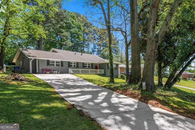 1954 Timothy Dr NE, Atlanta, GA 30329 - single story home with driveway, brick siding, a front yard, and covered porch