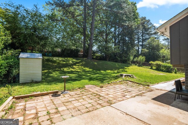 1954 Timothy Dr NE, Atlanta, GA 30329 - back of property with brick siding, board and batten siding, a patio, and roof with shingles