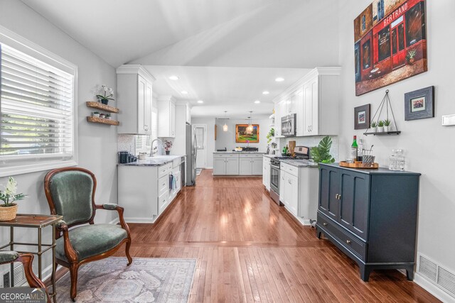 1954 Timothy Dr NE, Atlanta, GA 30329 - kitchen with stainless steel appliances, white cabinets, a sink, recessed lighting, and vaulted ceiling