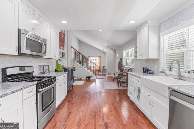 1954 Timothy Dr NE, Atlanta, GA 30329 - kitchen with appliances with stainless steel finishes, a sink, white cabinets, decorative backsplash, and recessed lighting