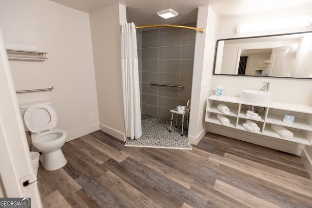 450 Warren Mason Blvd, Brunswick, GA 31520 - bathroom with a shower stall, toilet, baseboards, and wood finished floors