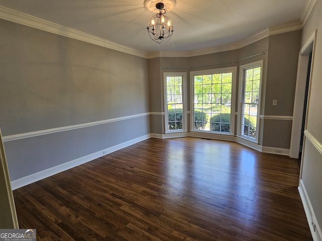 empty room featuring baseboards, a chandelier, ornamental molding, and dark wood finished floors