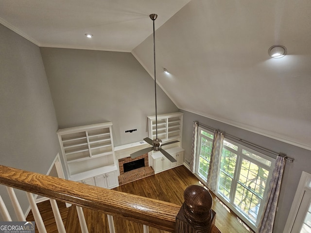 living room featuring stairway, lofted ceiling, ornamental molding, dark wood-type flooring, and ceiling fan