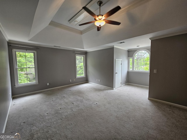 unfurnished room with a ceiling fan, crown molding, visible vents, and a raised ceiling