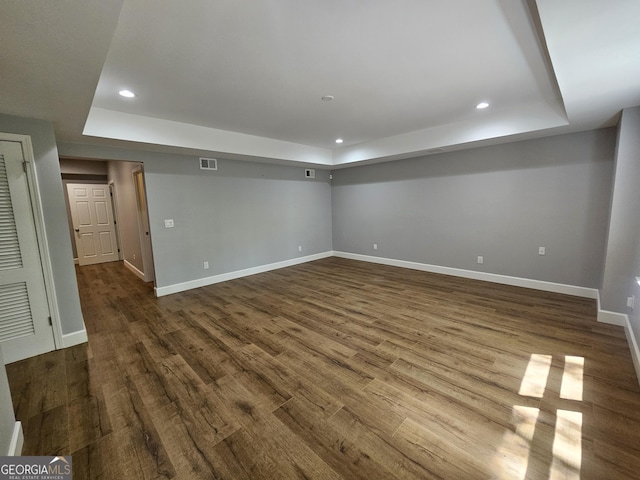 below grade area with recessed lighting, baseboards, visible vents, and dark wood-style floors