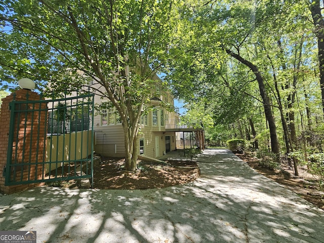 view of home's exterior featuring a gate and stairway