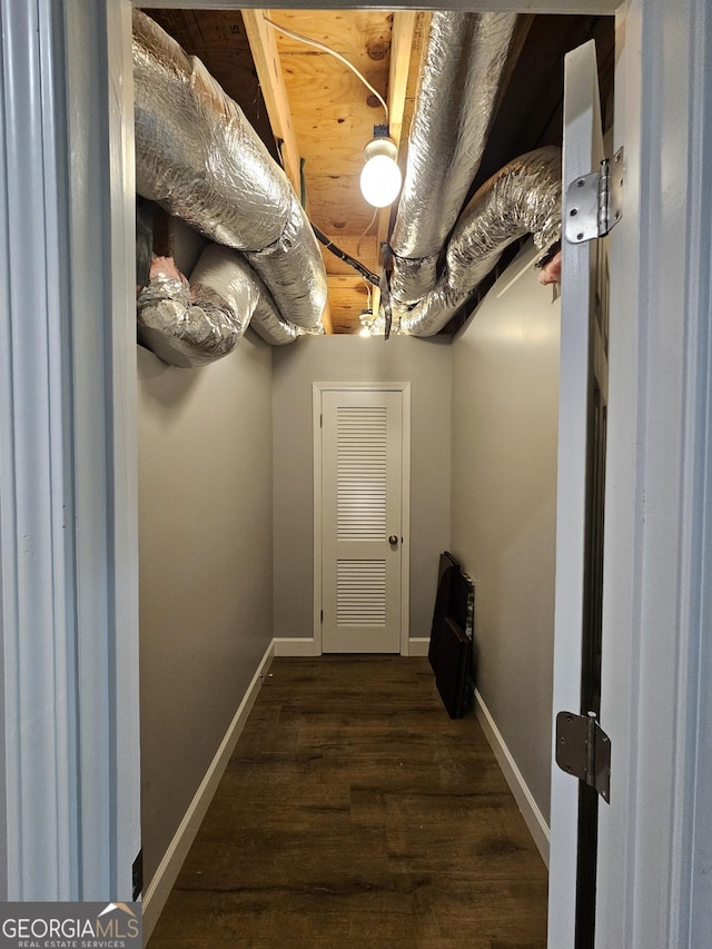 interior space featuring baseboards and wood finished floors