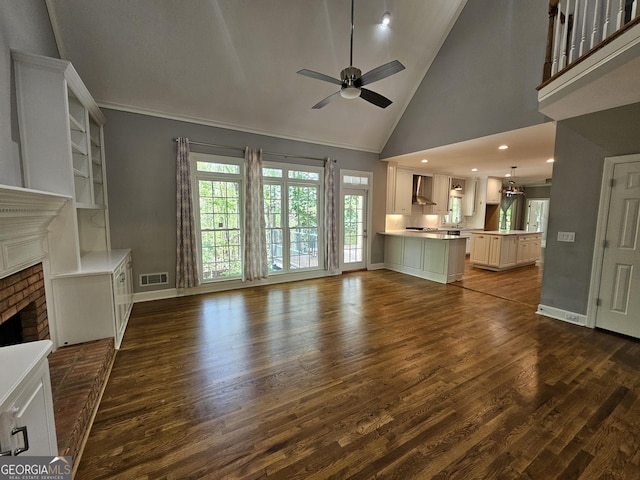 unfurnished living room featuring high vaulted ceiling, a ceiling fan, baseboards, a brick fireplace, and dark wood-type flooring