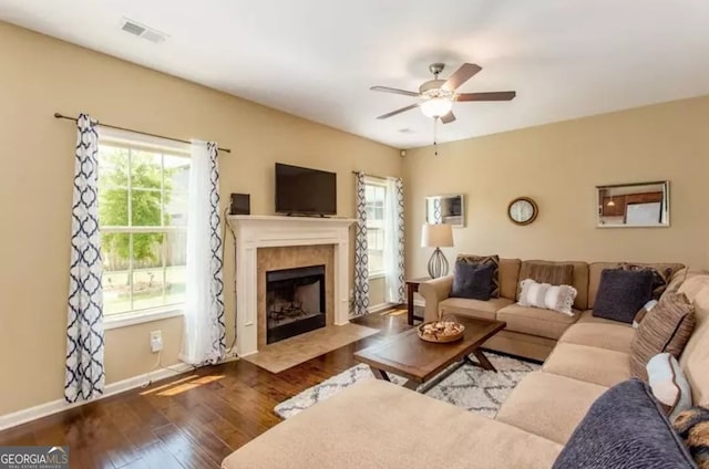 2 Hillshire Dr, Newnan, GA 30263 - living area featuring a ceiling fan, baseboards, a tiled fireplace, visible vents, and wood finished floors