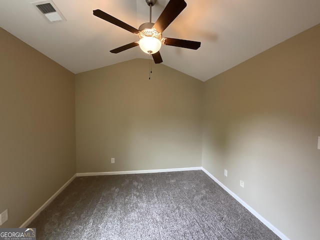 2 Hillshire Dr, Newnan, GA 30263 - spare room with baseboards, ceiling fan, visible vents, vaulted ceiling, and dark carpet