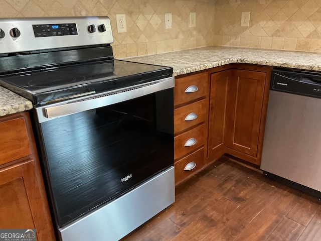 2 Hillshire Dr, Newnan, GA 30263 - kitchen featuring brown cabinets, decorative backsplash, dark wood-type flooring, and appliances with stainless steel finishes