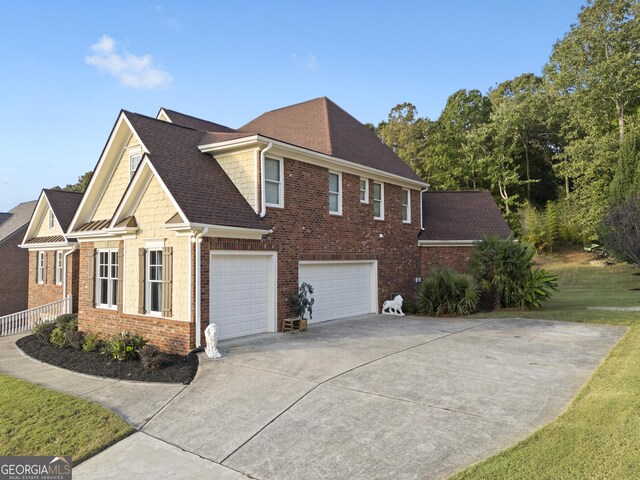 view of property exterior featuring an attached garage, brick siding, roof with shingles, and concrete driveway