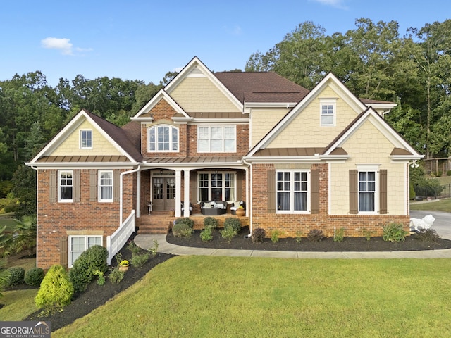 view of front of property with a front lawn and brick siding