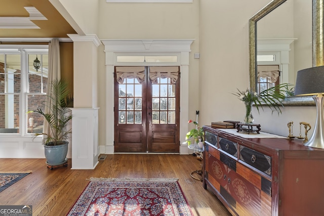 foyer featuring french doors and wood finished floors