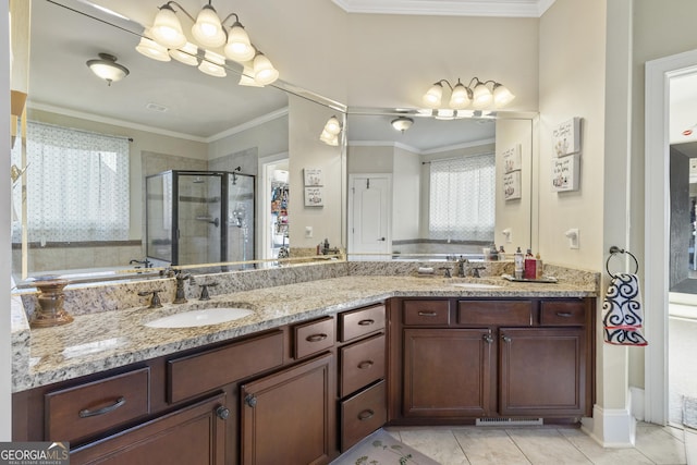 full bathroom featuring double vanity, a stall shower, and a sink