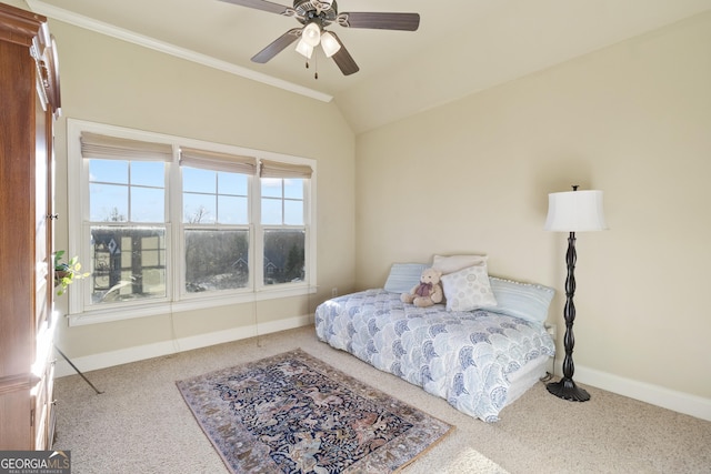carpeted bedroom featuring a ceiling fan, baseboards, crown molding, and lofted ceiling
