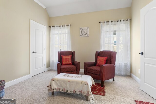 sitting room with vaulted ceiling, baseboards, and carpet floors