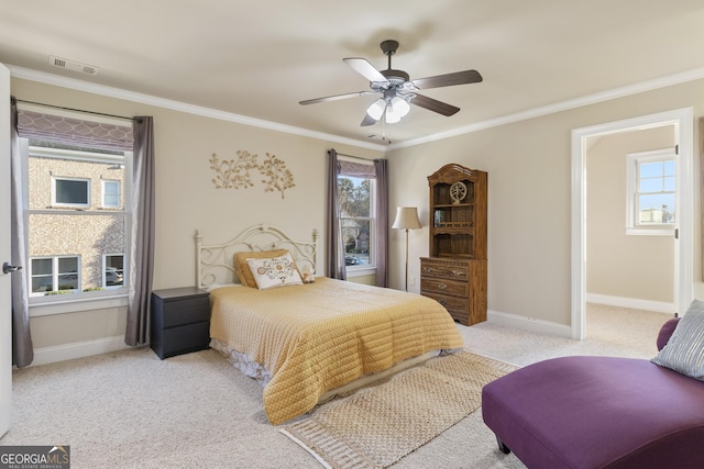 bedroom with a ceiling fan, crown molding, light colored carpet, baseboards, and visible vents
