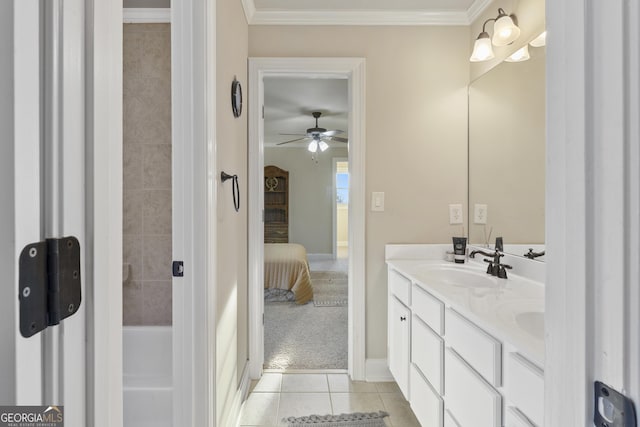 bathroom featuring tile patterned floors, a sink, ceiling fan, double vanity, and ensuite bath