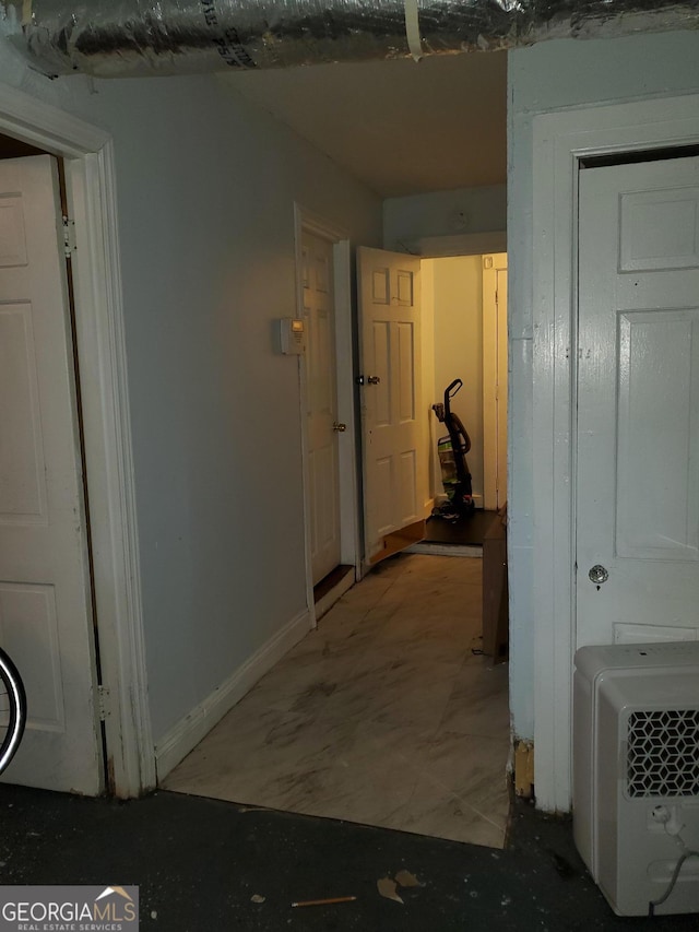 hall featuring baseboards