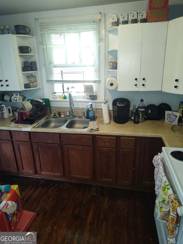 kitchen with white range with electric stovetop, open shelves, a sink, light countertops, and dark wood-style floors