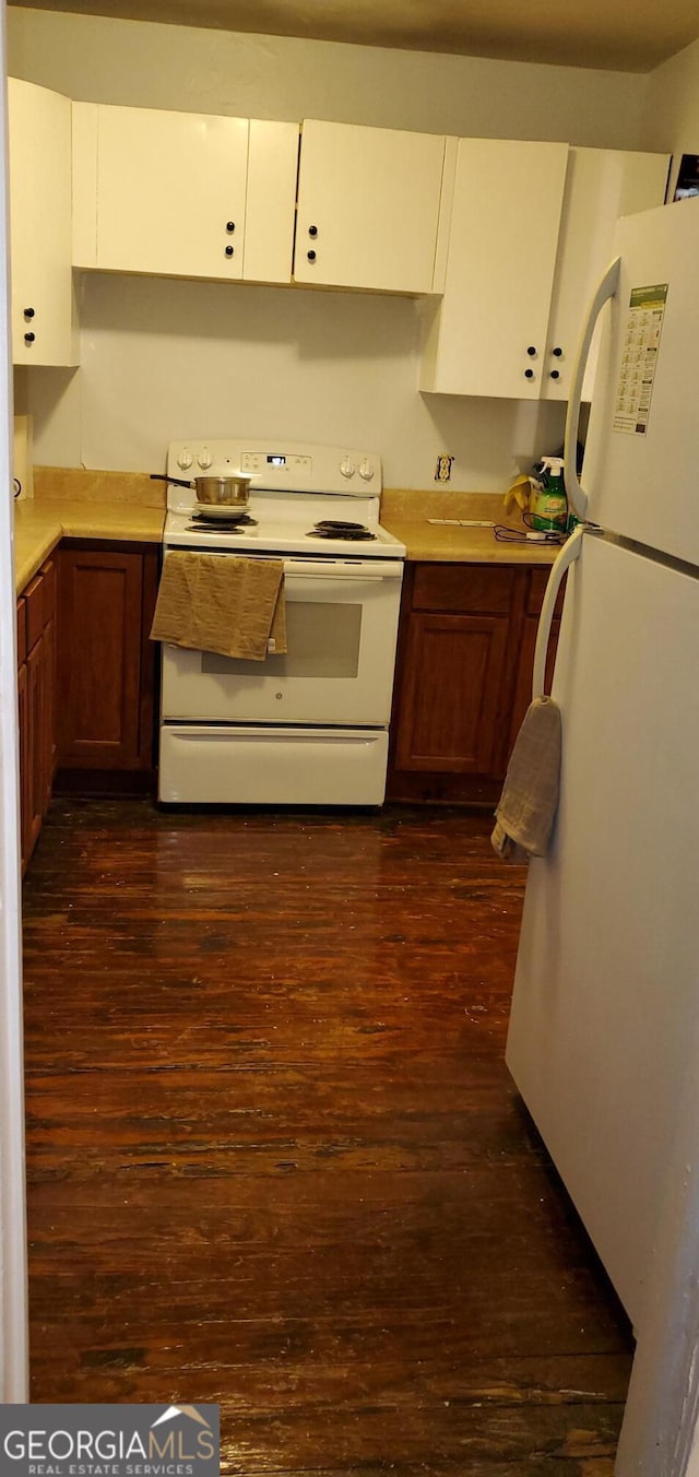 kitchen with white cabinets, brown cabinets, dark wood-style floors, light countertops, and white appliances