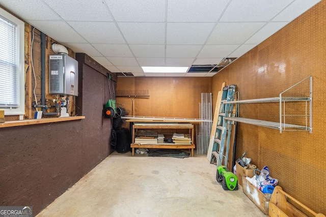 basement with a workshop area and a drop ceiling