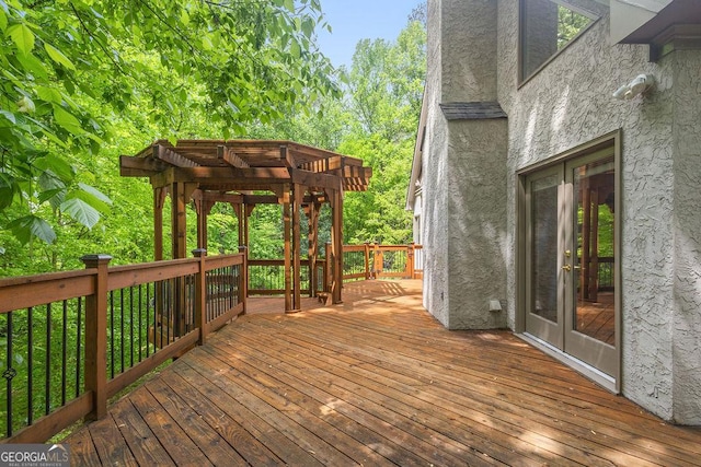 wooden deck with a pergola and french doors