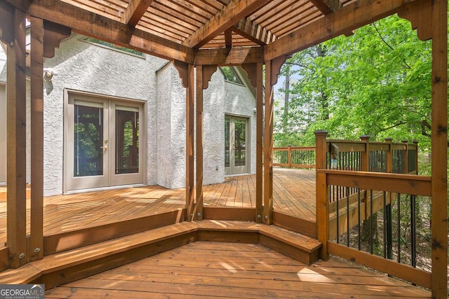 wooden deck with a pergola and french doors