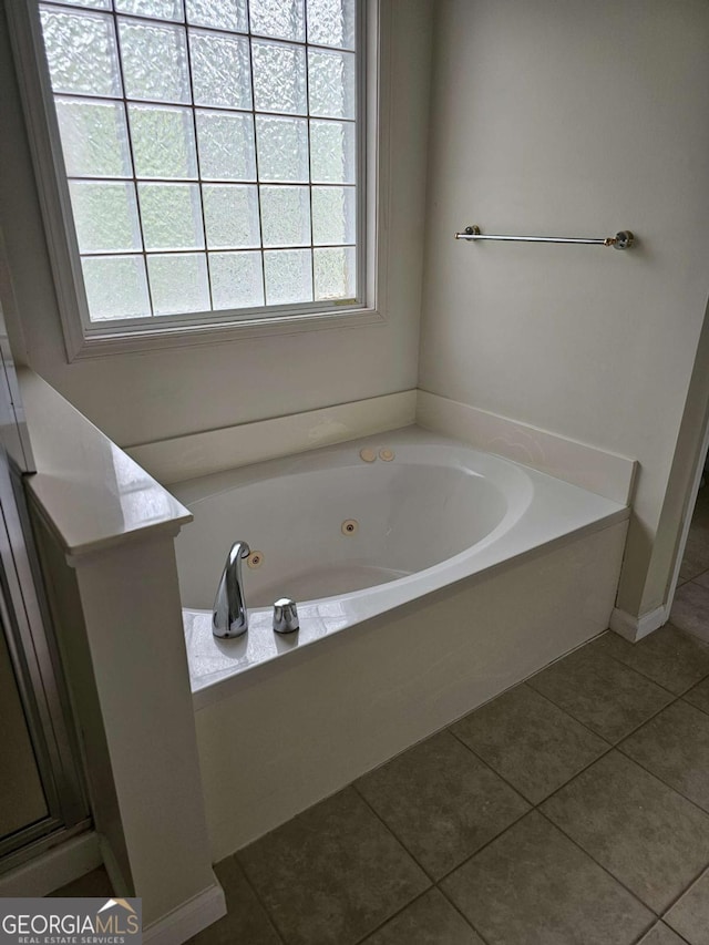 5114 Verbena Dr NW, Acworth, GA 30102 - bathroom with a jetted tub, a wealth of natural light, and tile patterned flooring