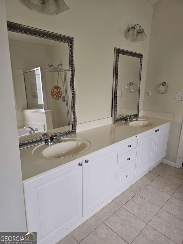 5114 Verbena Dr NW, Acworth, GA 30102 - full bathroom featuring double vanity, tile patterned flooring, a stall shower, and a sink