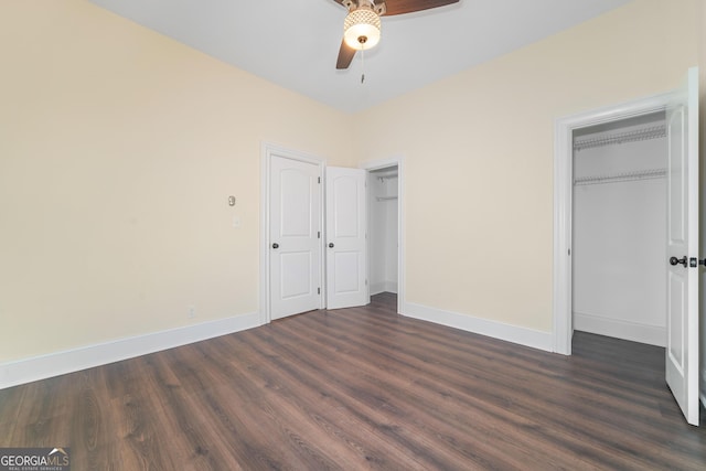 26 Walker St, Cartersville, GA 30120 - unfurnished bedroom with multiple closets, baseboards, ceiling fan, and dark wood-style floors