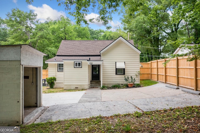 26 Walker St, Cartersville, GA 30120 - back of property with fence, a storage unit, a shingled roof, a patio area, and an outdoor structure