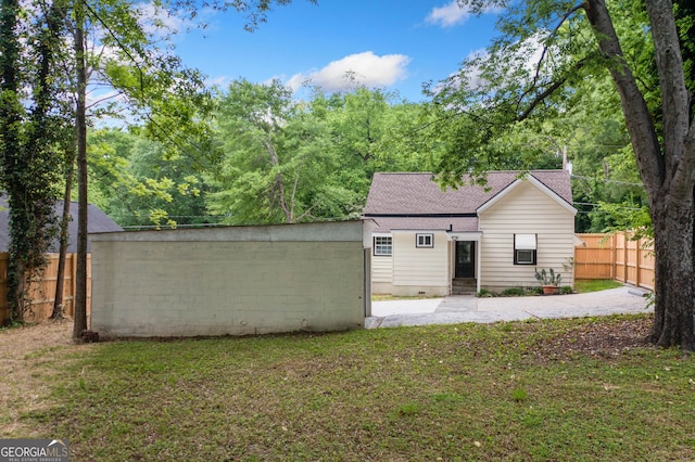 26 Walker St, Cartersville, GA 30120 - back of house with a lawn, fence, and roof with shingles
