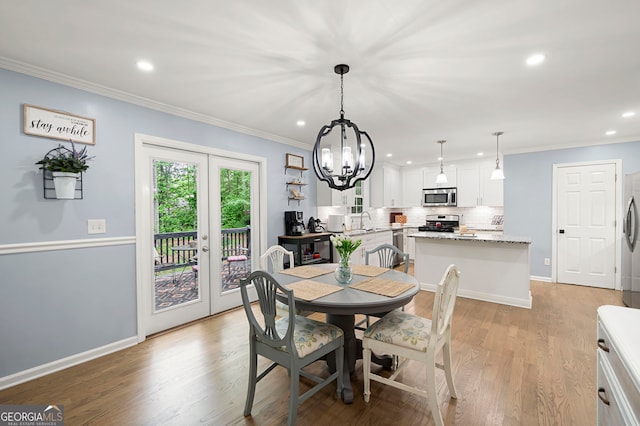 57 Glenn Eagles Way, Hiram, GA 30141 - dining room featuring recessed lighting, a chandelier, light wood-style flooring, crown molding, and baseboards