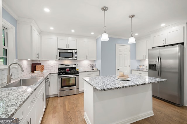 57 Glenn Eagles Way, Hiram, GA 30141 - kitchen featuring stainless steel appliances, a sink, decorative backsplash, light wood-type flooring, and white cabinetry