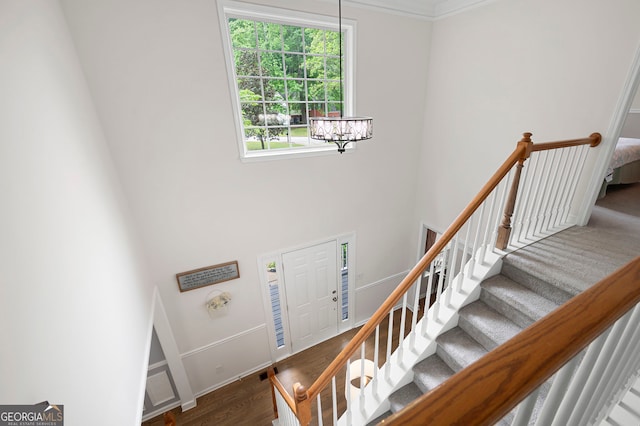 57 Glenn Eagles Way, Hiram, GA 30141 - stairway with wood finished floors, a chandelier, baseboards, and a towering ceiling