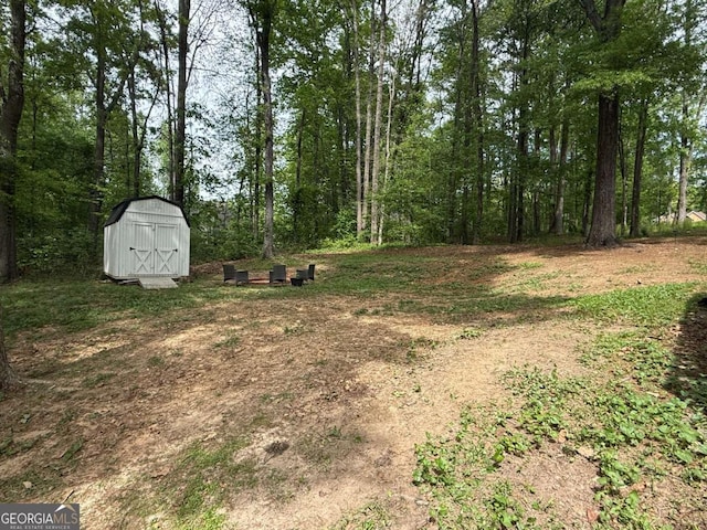 view of yard with a storage unit and an outbuilding